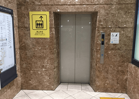 こちらのエレベーターをご利用ください。お乗りいただきましたら、地上1Fにお上がりください。